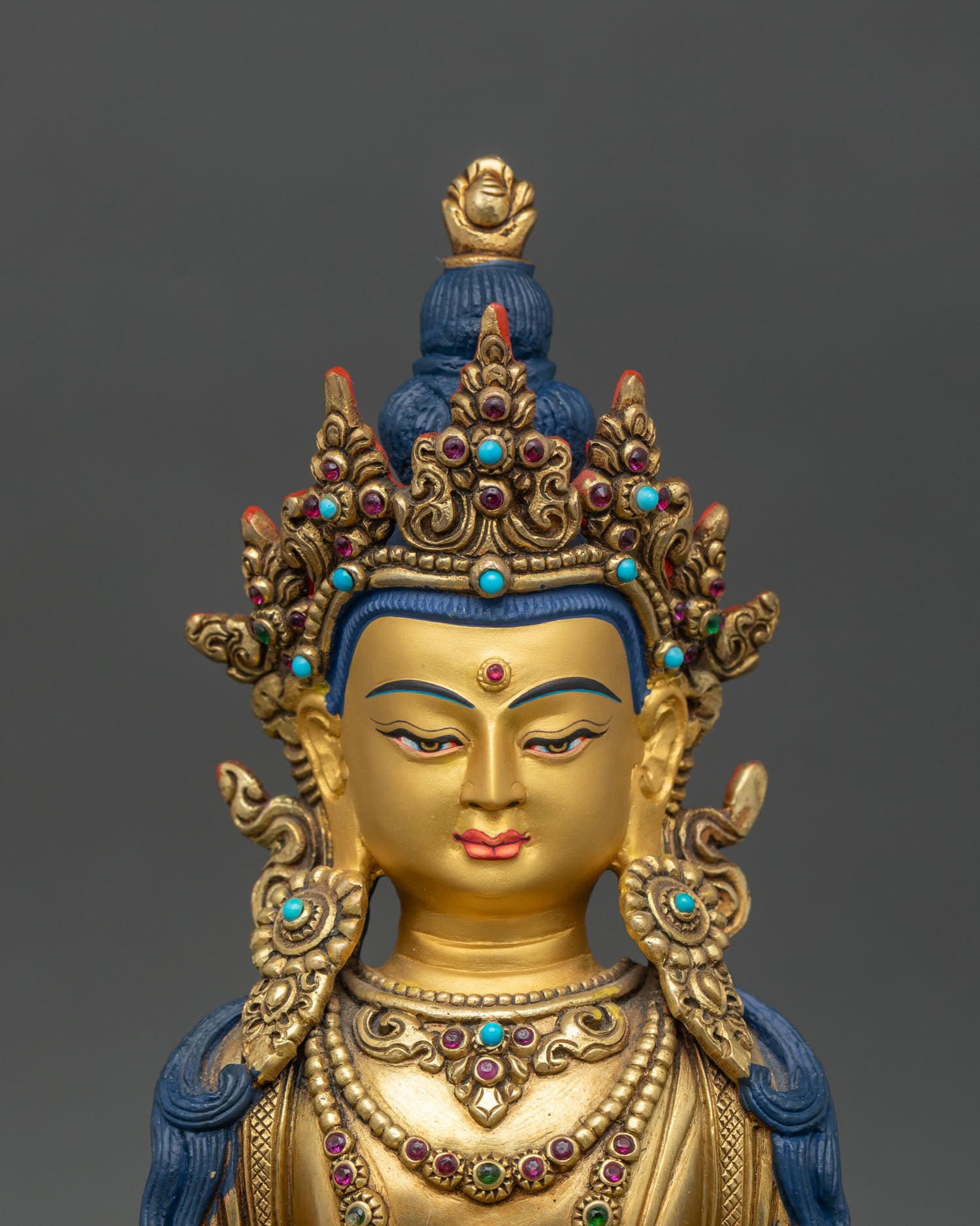 Regular close-up of Amitayus statue showing intricate copper and gold details