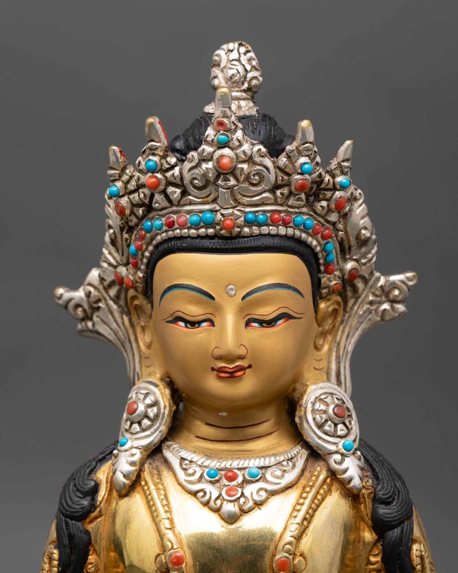 regular close up of amitayus statue showing intricate floral and motif designs