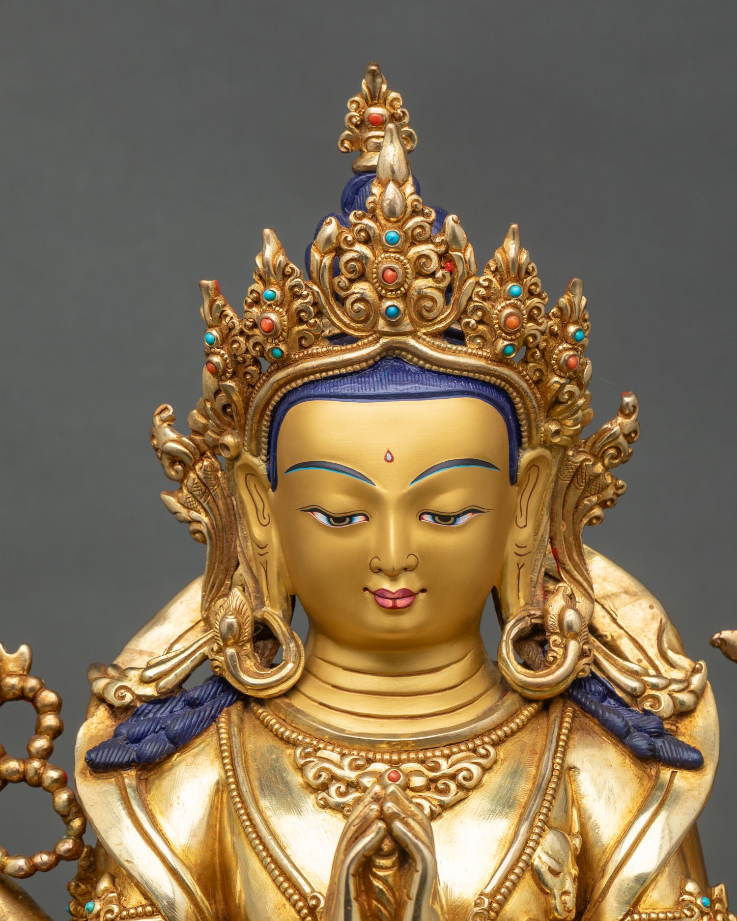 Regular close-up of Chenrezig statue showing intricate copper and gold details