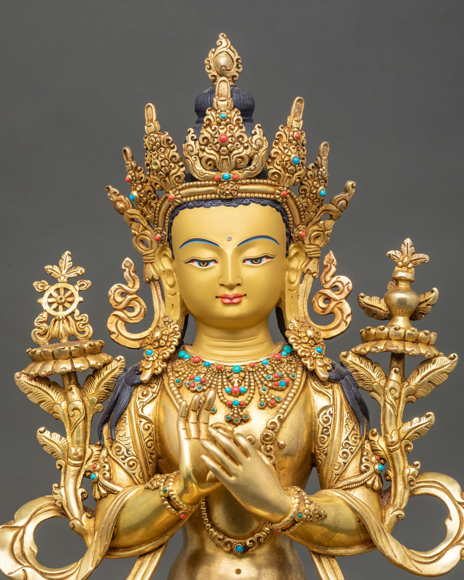 regular close up of maitreya buddha statue showing intricate copper and gold details