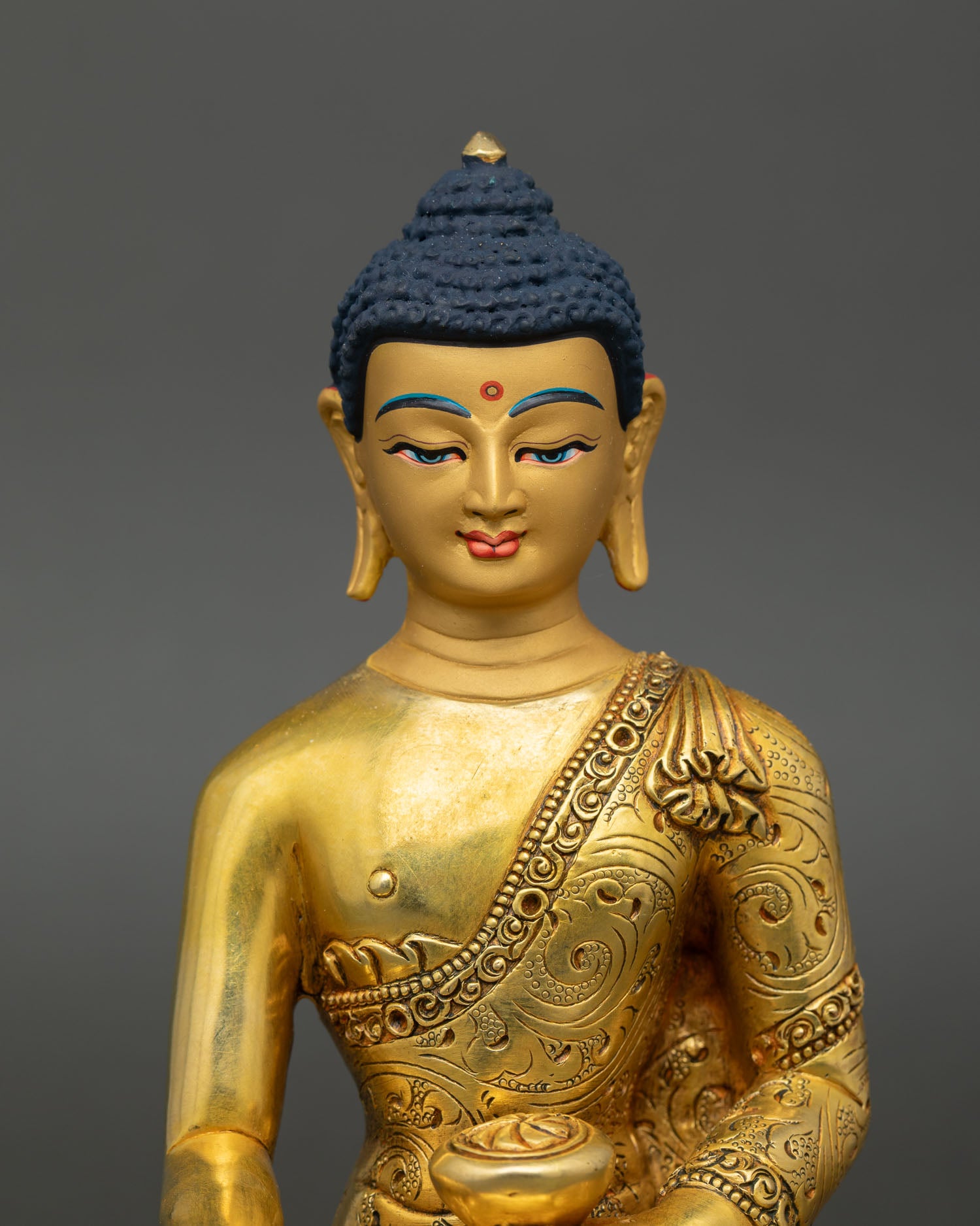 regular close-up of shakyamuni buddha statue showing detailed copper and gold artwork