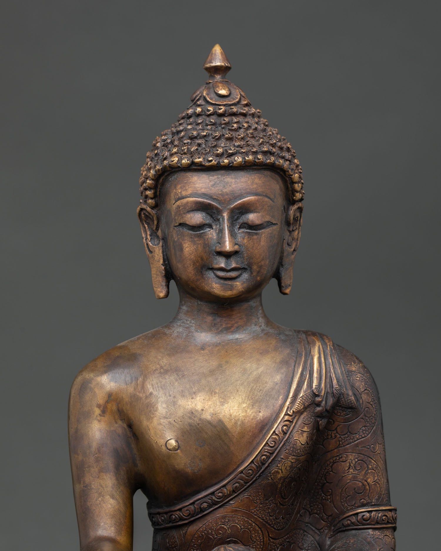 Regular close up of Shakyamuni Buddha statue with antique finish and handcrafted copper details