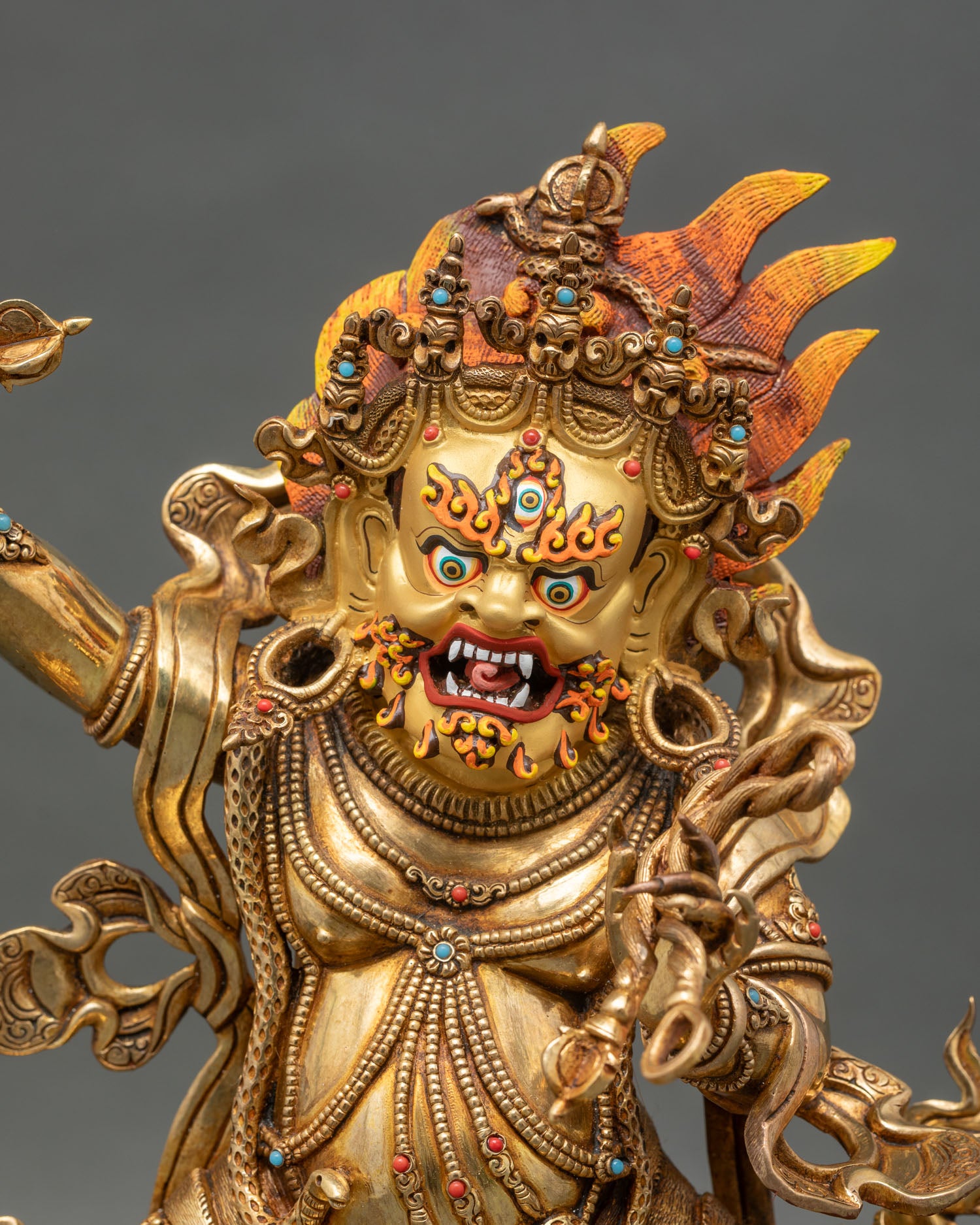 regular close up of vajrapani statue showing copper and gold details