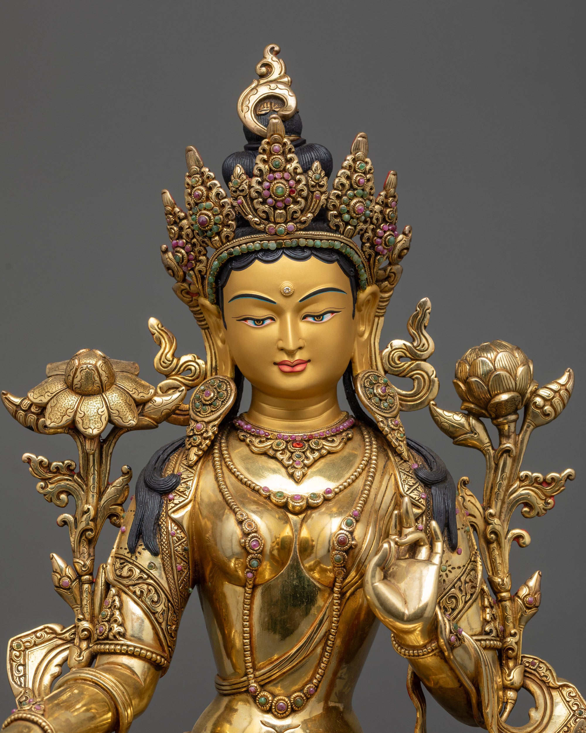 regular close up Green Tara statue showing semi-precious stone lotus base and robes