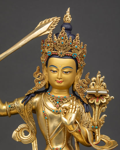regular close up Manjushri Buddha statue showing intricate lotus seat and gold gilding
