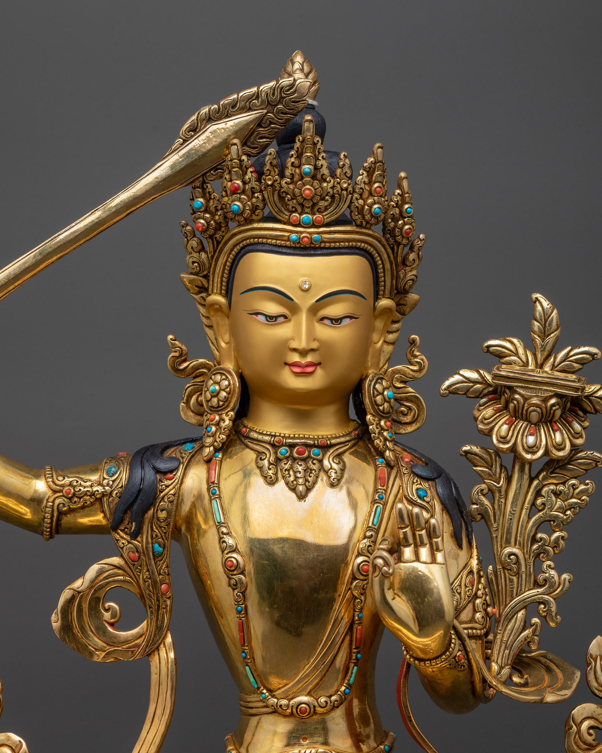 regular close up Manjushri Statue holding utpala flower with Prajnaparamita sutra and sword
