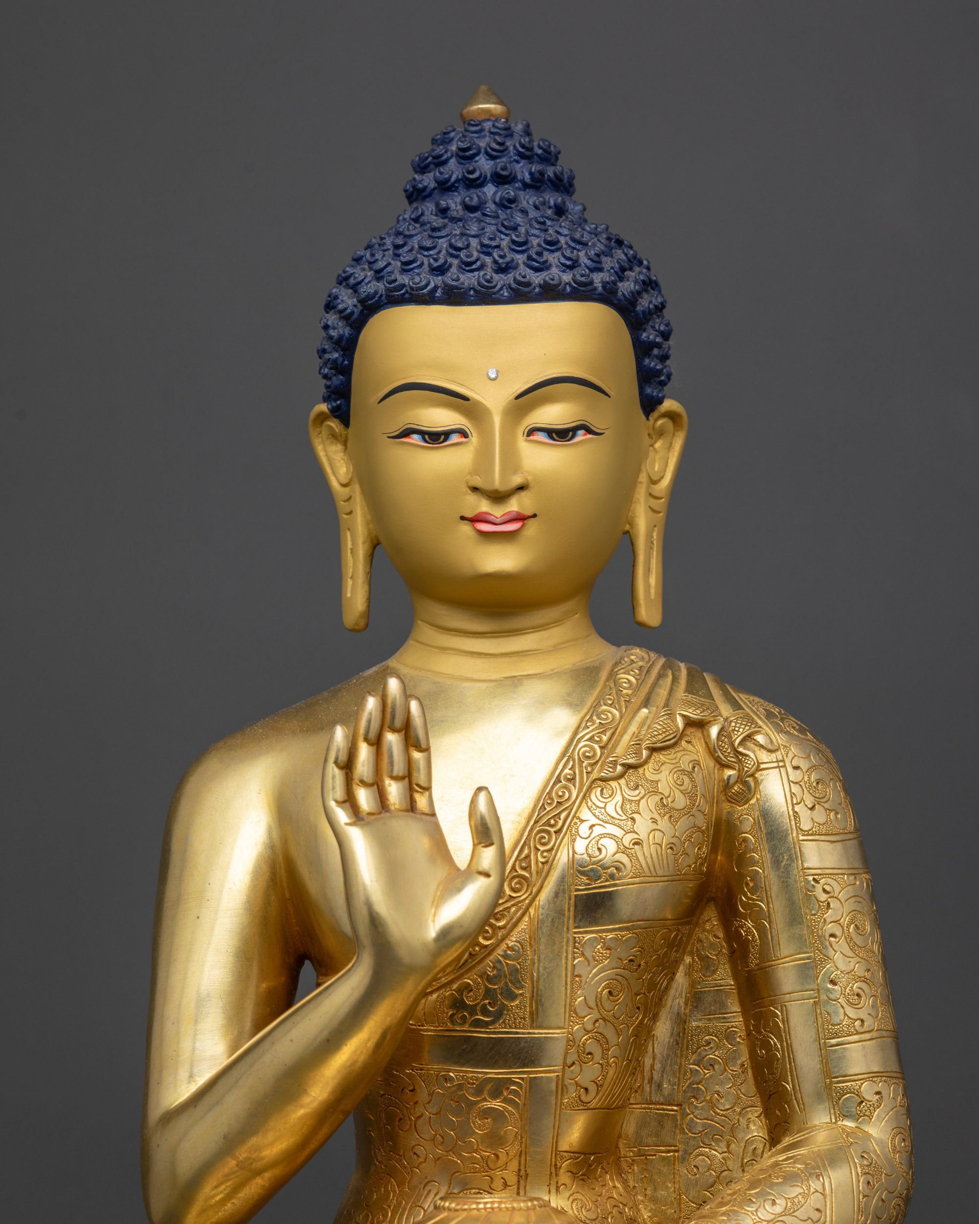 regular close up amoghasiddhi buddha statue polished finish with floral carved robe
