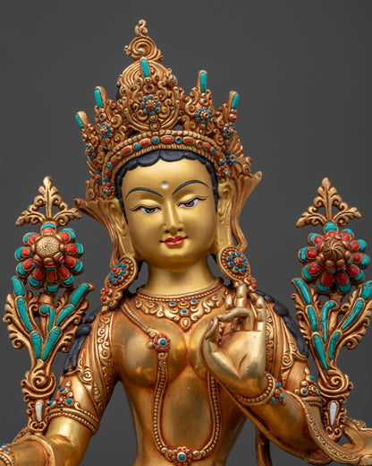 regular close up green tara buddhist idol showing utpala flower and jeweled crown
