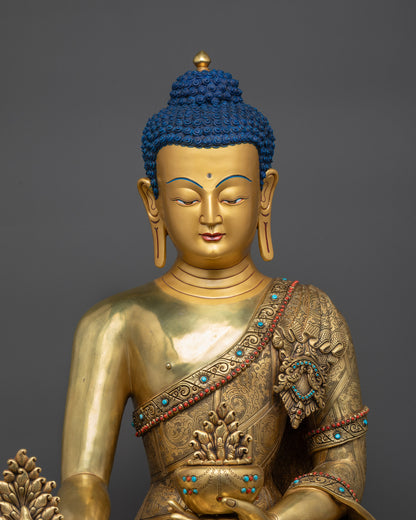 regular close up of Medicine Buddha Statue showing robe patterns and semi-precious stone inlays
