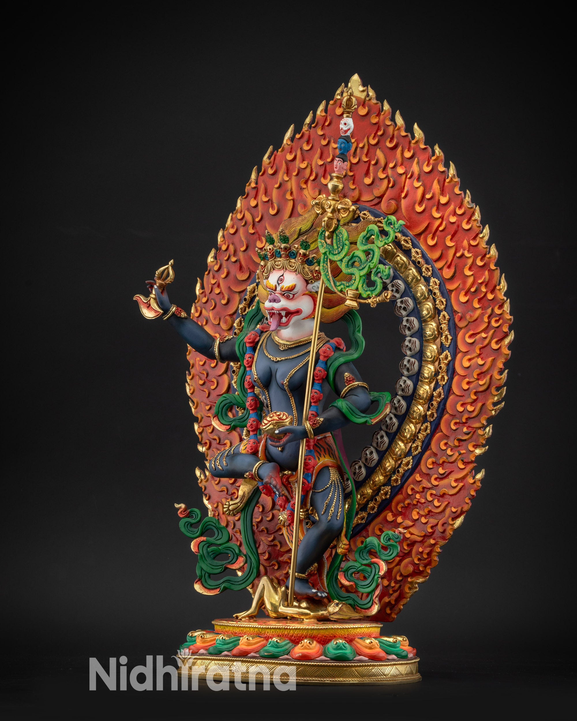 regular left side view Simha Mukha statue with detailed ornaments and green silken robe
