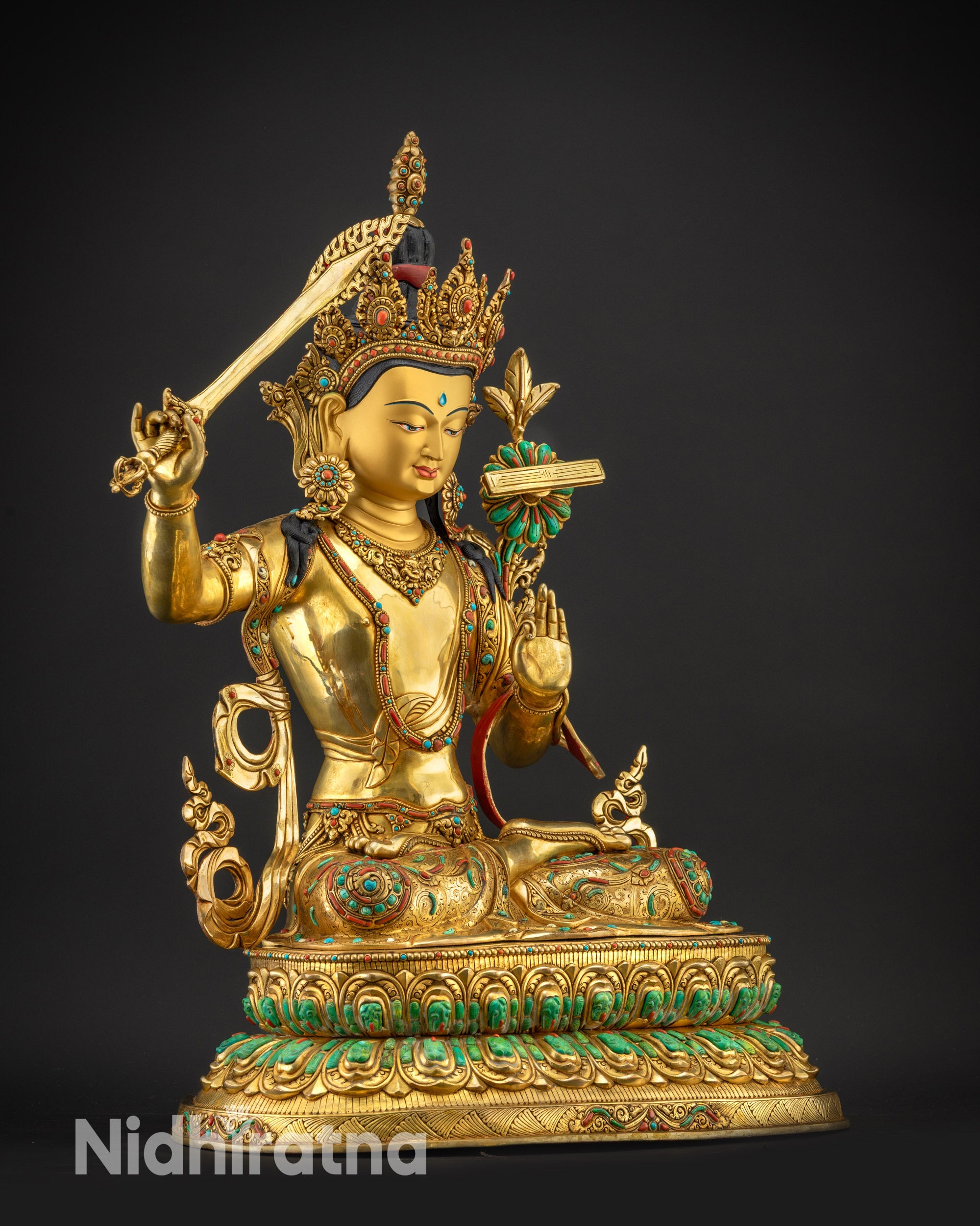 regular right side view Manjushri sculpture holding sword and utpala flower
