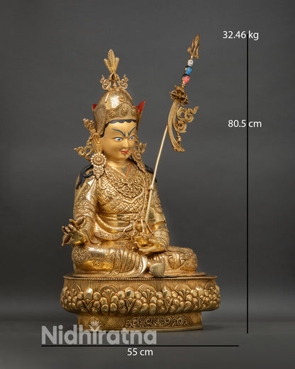 right profile guru rinpoche statue, showing trident khatvanga and layered monastic robes with gold finish