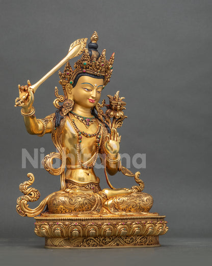 Right side profile view of handcrafted gold-gilded copper Manjushri statue from Nepal.