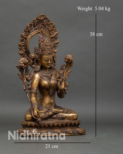 Right side view of antique White Tara statue with lotus base and ornate halo design