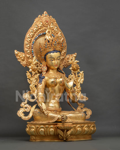 Right side view of Green Tara statue with fire-gilded lotus throne
