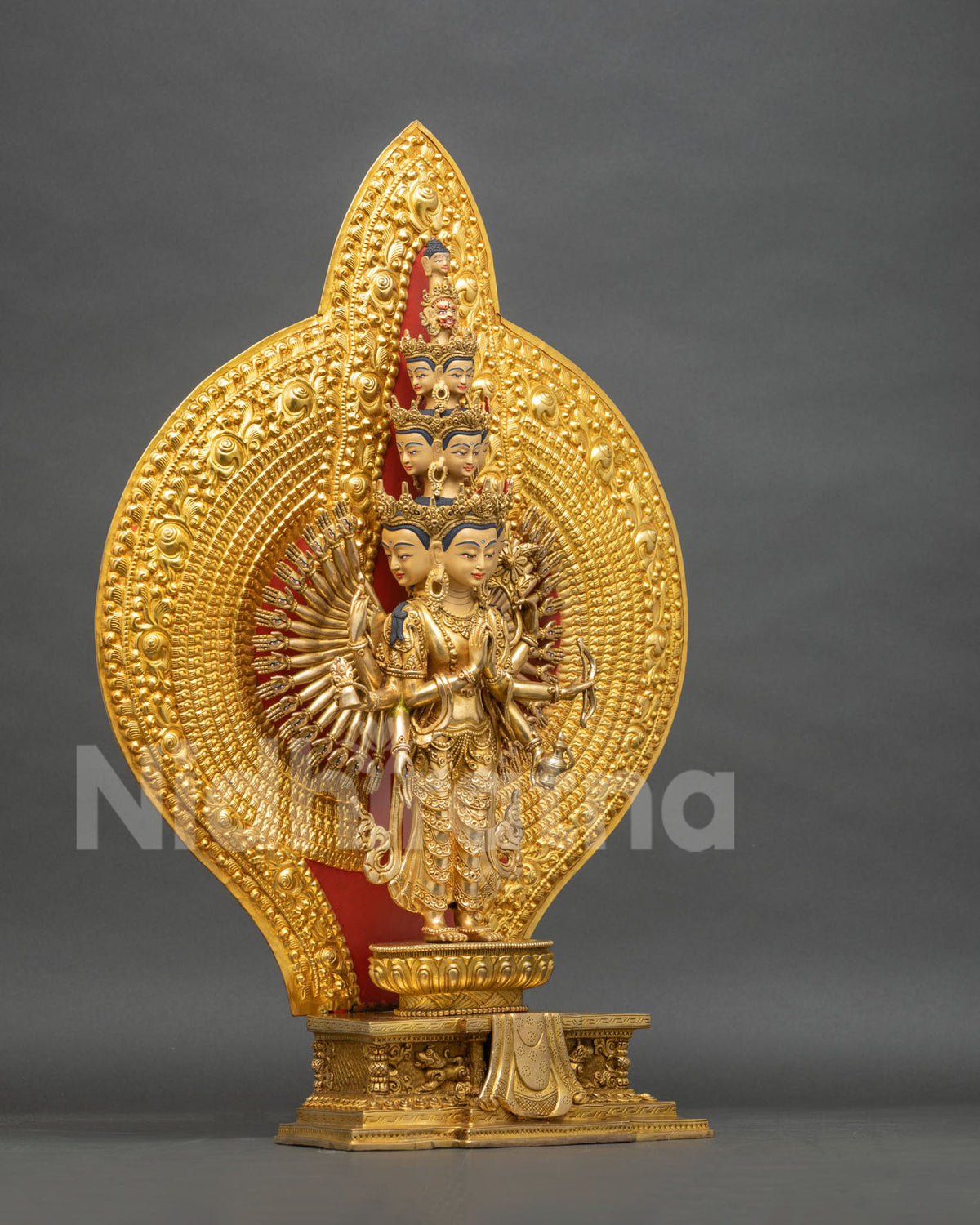 Right side view of 1000 Arm Chenrezig statue with fan of palm-eye hands and layered gold halo, Nepal