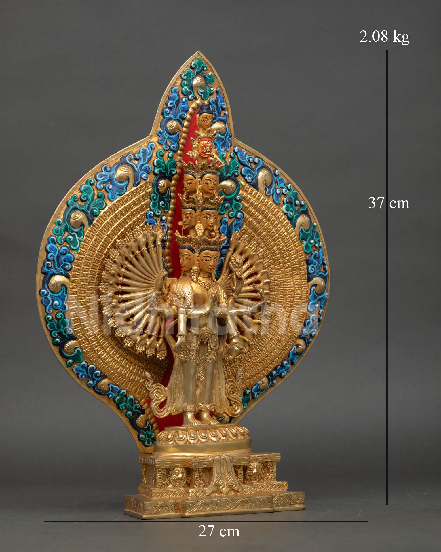 right side view of 1000 armed chenrezig statue with radiant halo and sacred arms