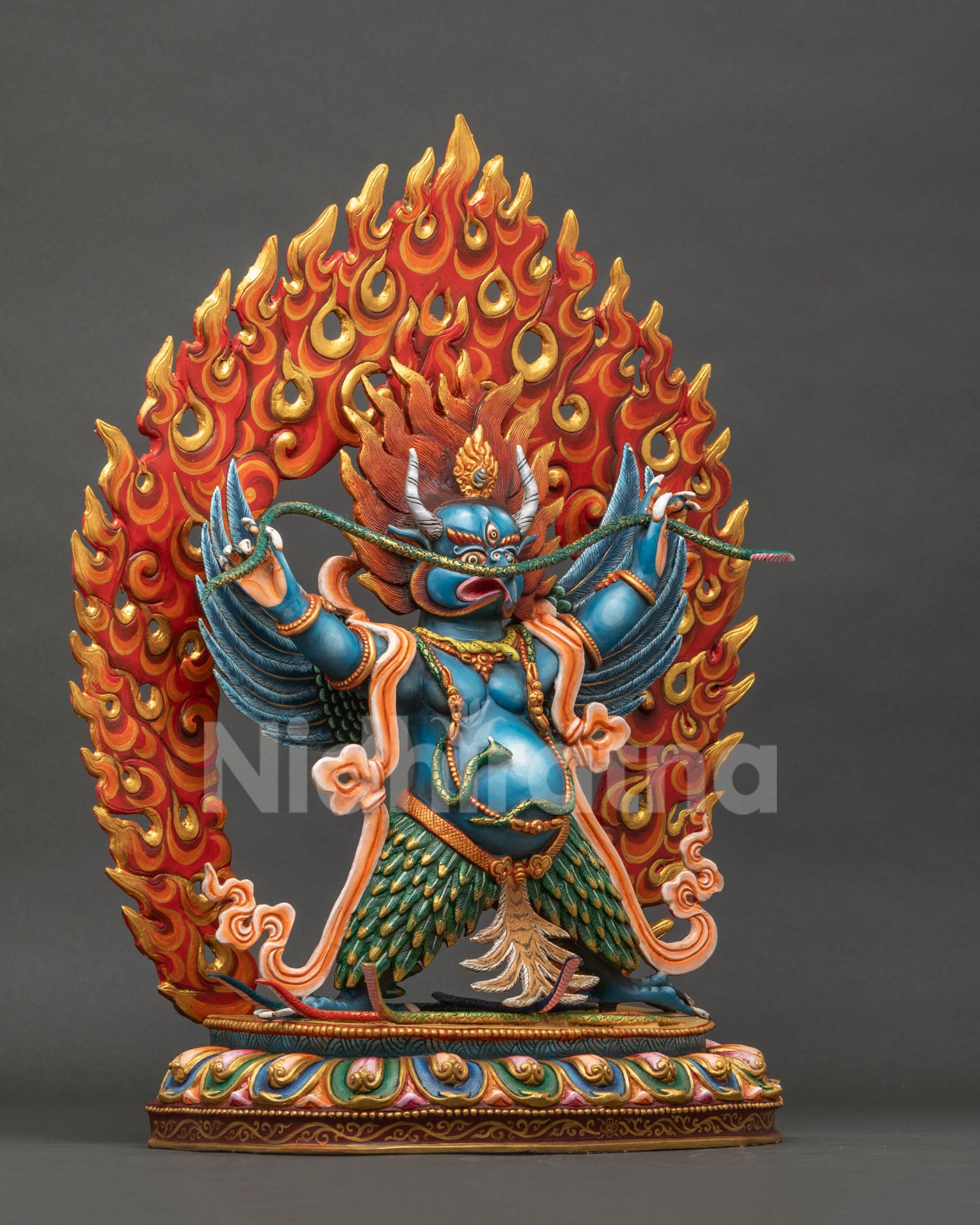 Right side view of blue Garuda statue with flaming halo