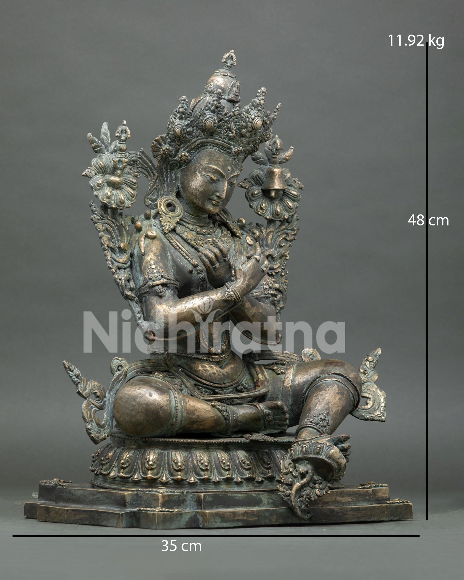 Right side view of bronze Vajradhara statue with lotus, vajra, and bell details