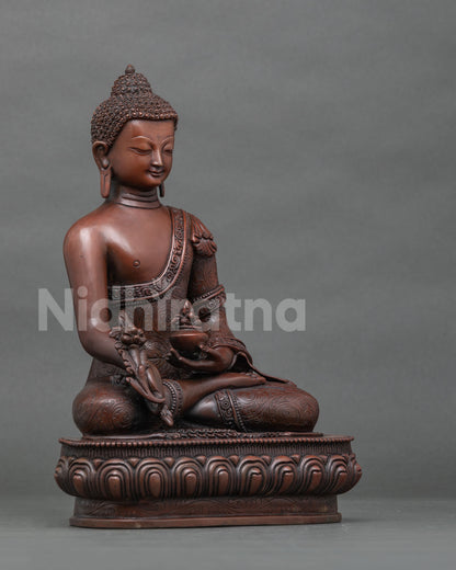Right side view of copper Bhaisajyaguru Medicine Buddha statue on lotus pedestal