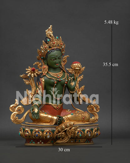 Right side view of copper Green Tara statue displaying Utpala flower and Varada Mudra.