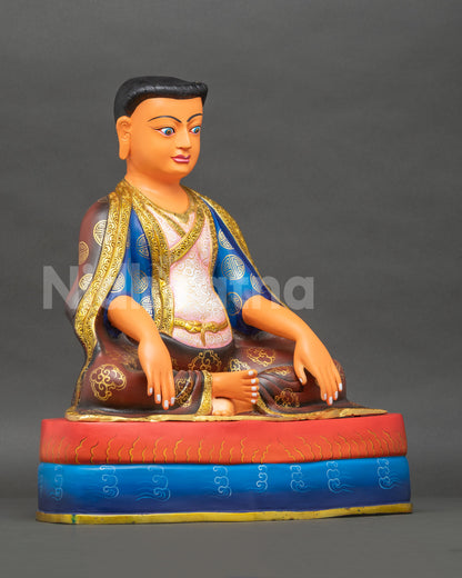 right side view of copper marpa lotsawa statue seated in meditation on a double pedestal