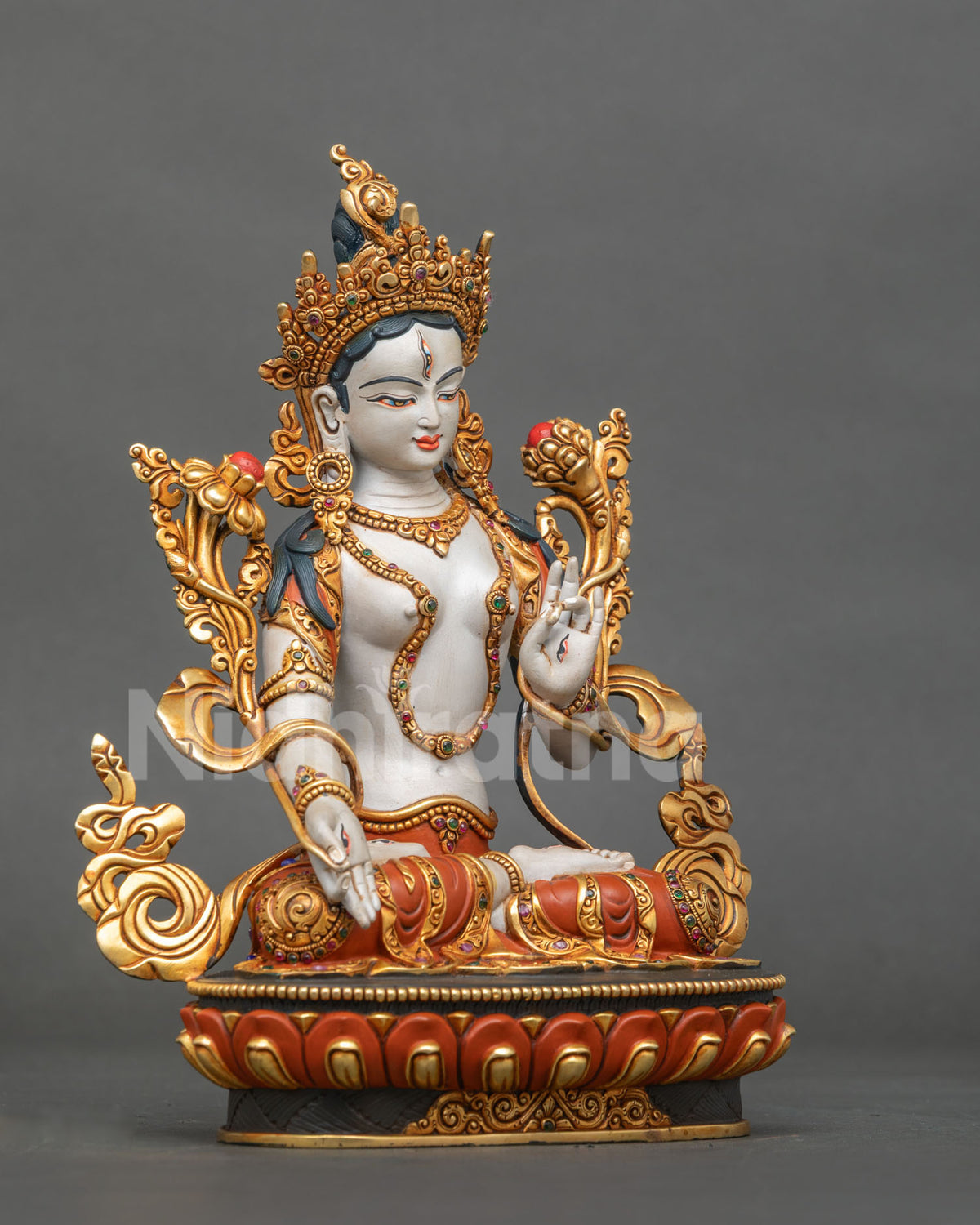 right side view of copper white tara statue with gold gilded lotus scrollwork