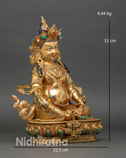 Right side view of Dzambhala statue seated with mongoose and treasure vase