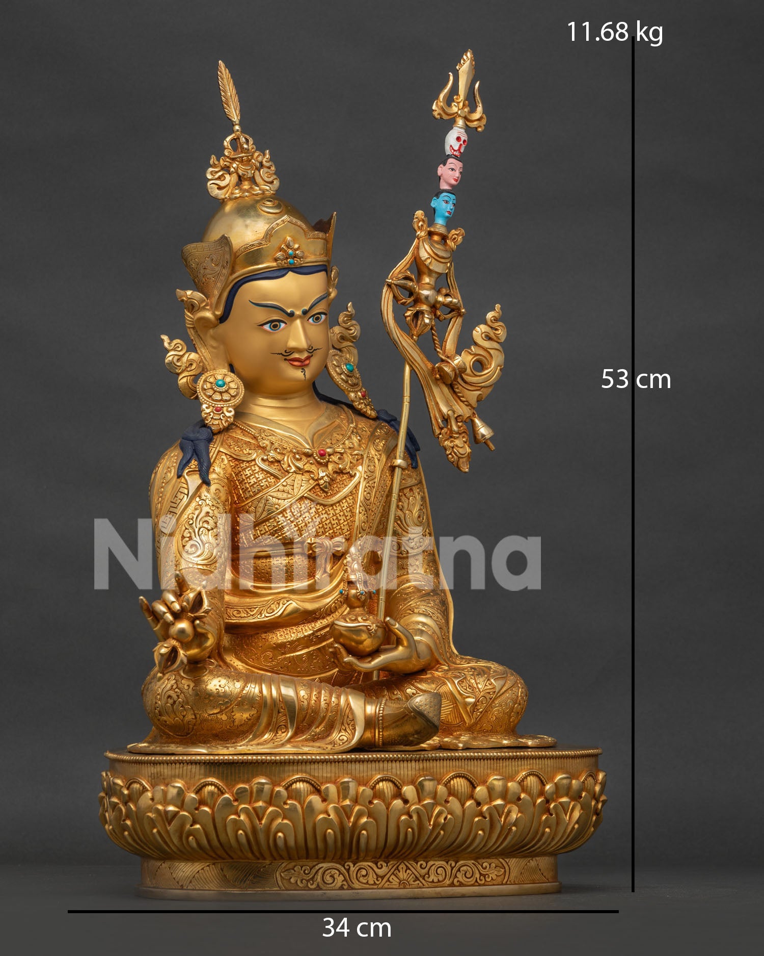 Right side view of gold Guru Rinpoche Padmasambhava statue with khatvanga staff and lotus throne.