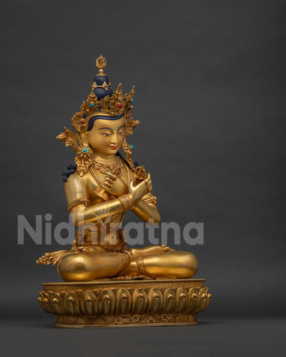 Right side view of gold Vajradhara statue seated on a hand-carved lotus pedestal