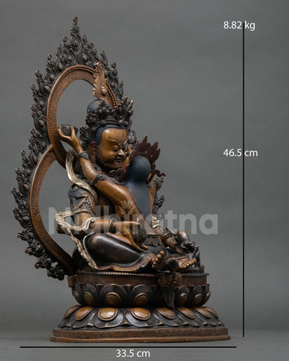 right side view of green dzambhala prosperity deity statue with flaming prabhavali halo