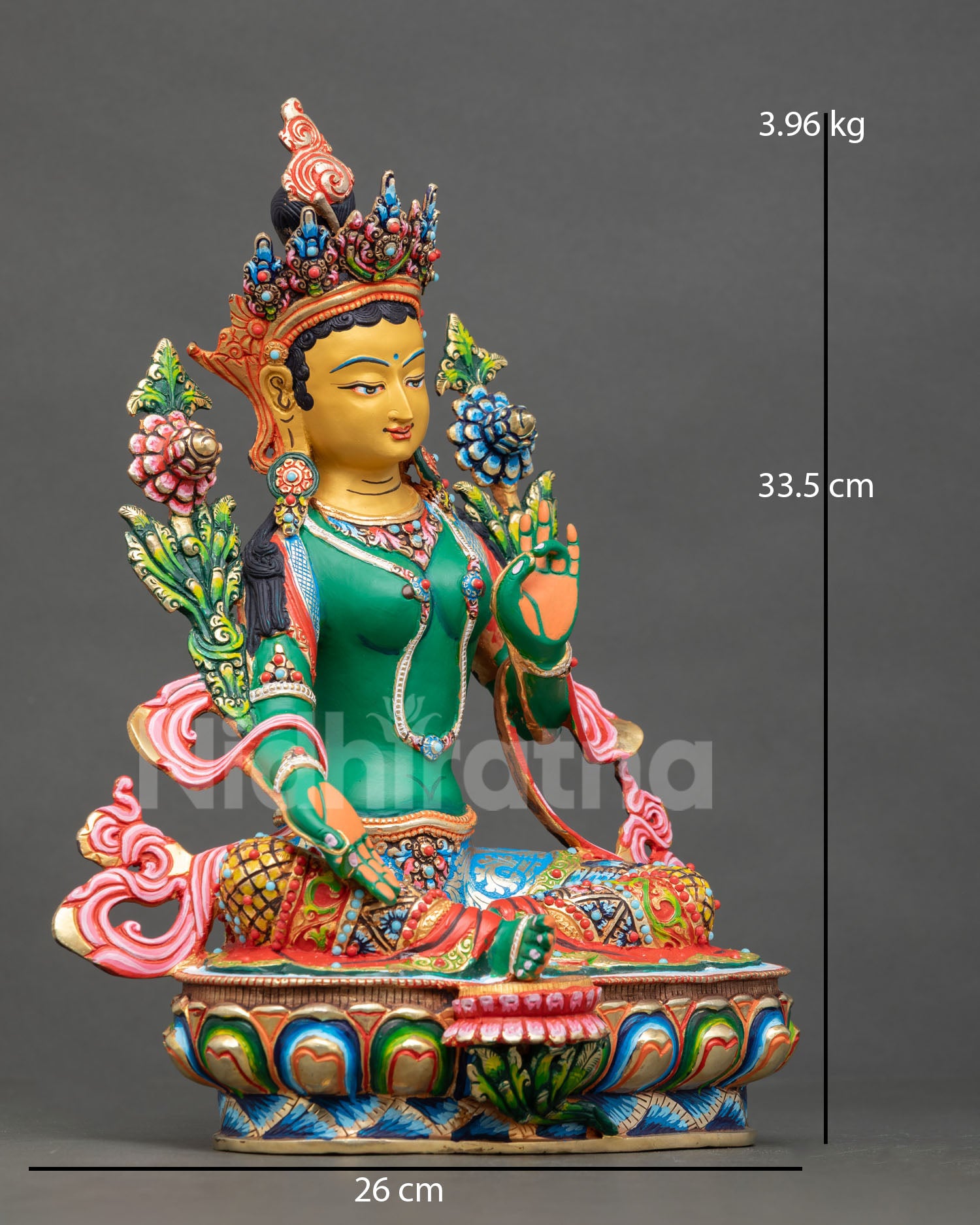 right side view of green tara sculpture holding blue lotus on lotus throne