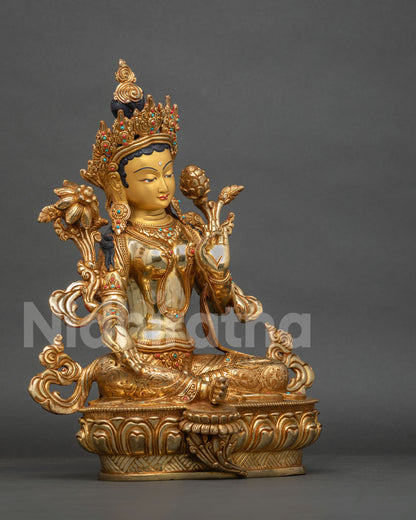 Right side view of Green Tara statue, gold gilded copper sculpture seated on lotus pedestal