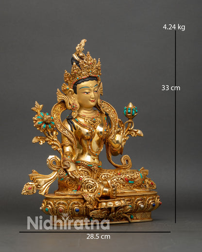 right side view of green tara statue, handcrafted nepalese buddhist copper and gold sculpture