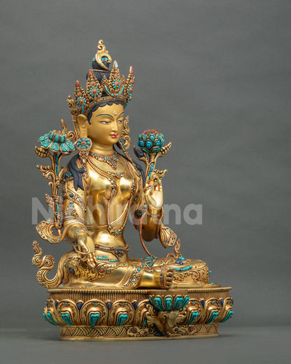 Right side view of Green Tara statue in Lalitasana pose with Varada mudra on a carved lotus throne
