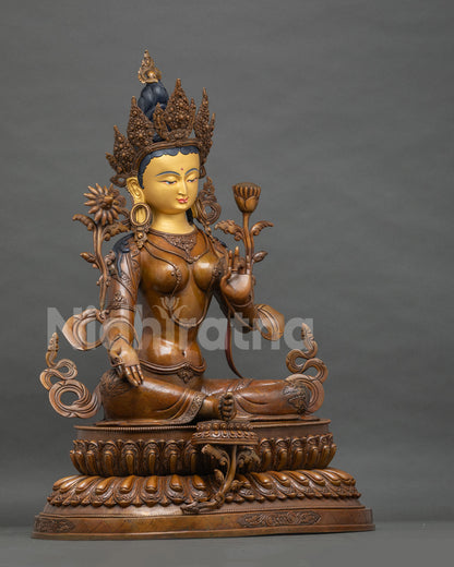 Right side view of Green Tara statue, right hand in varada mudra, boundless generosity