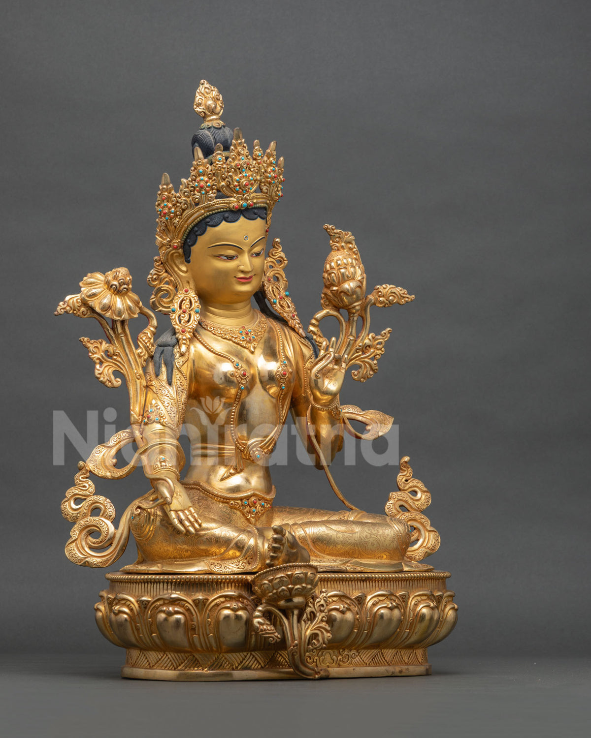 Right side view of Green Tara statue with extended leg resting on lotus, Nepal copper