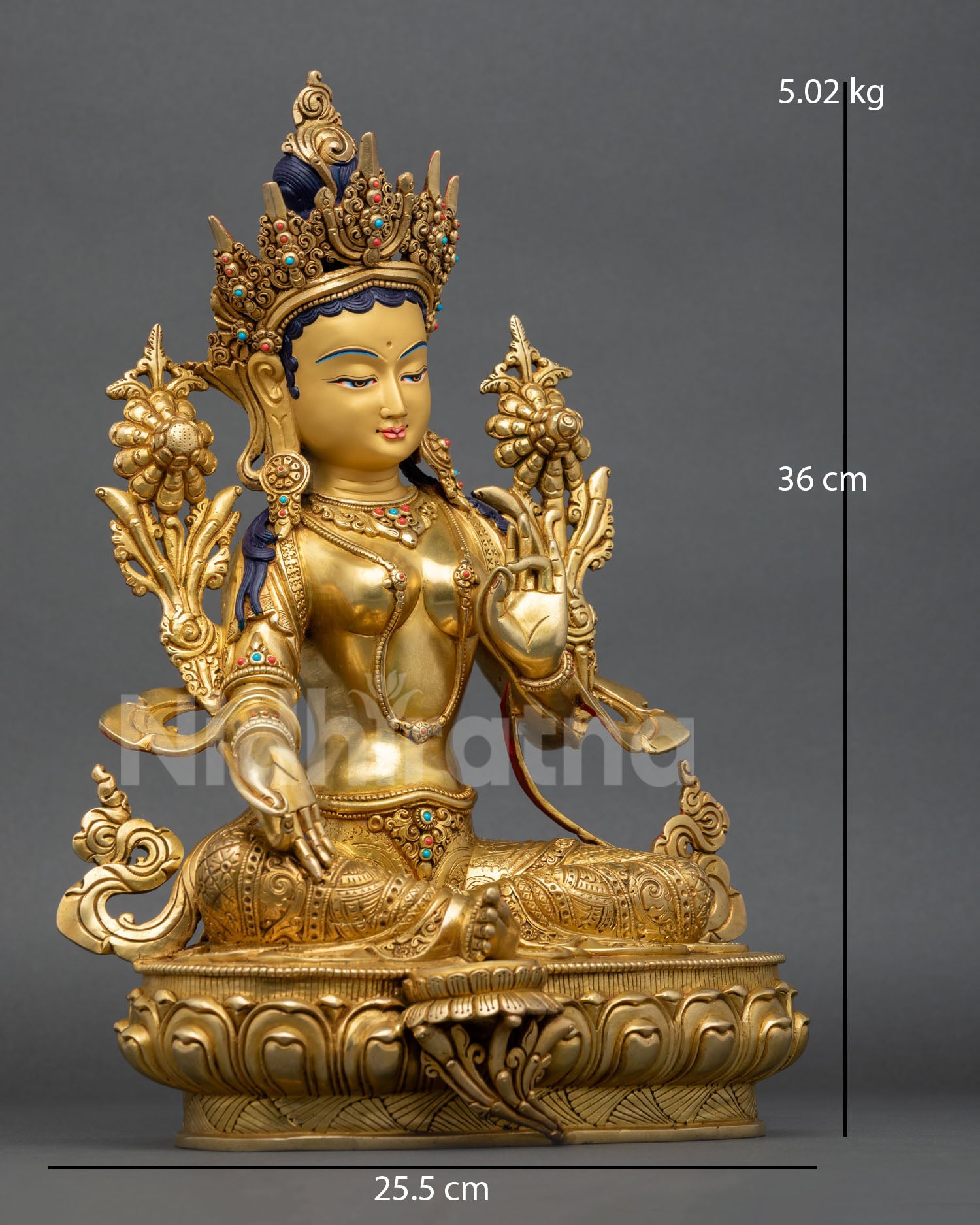 right side view of green tara statue with utpala flower and lotus pedestal details
