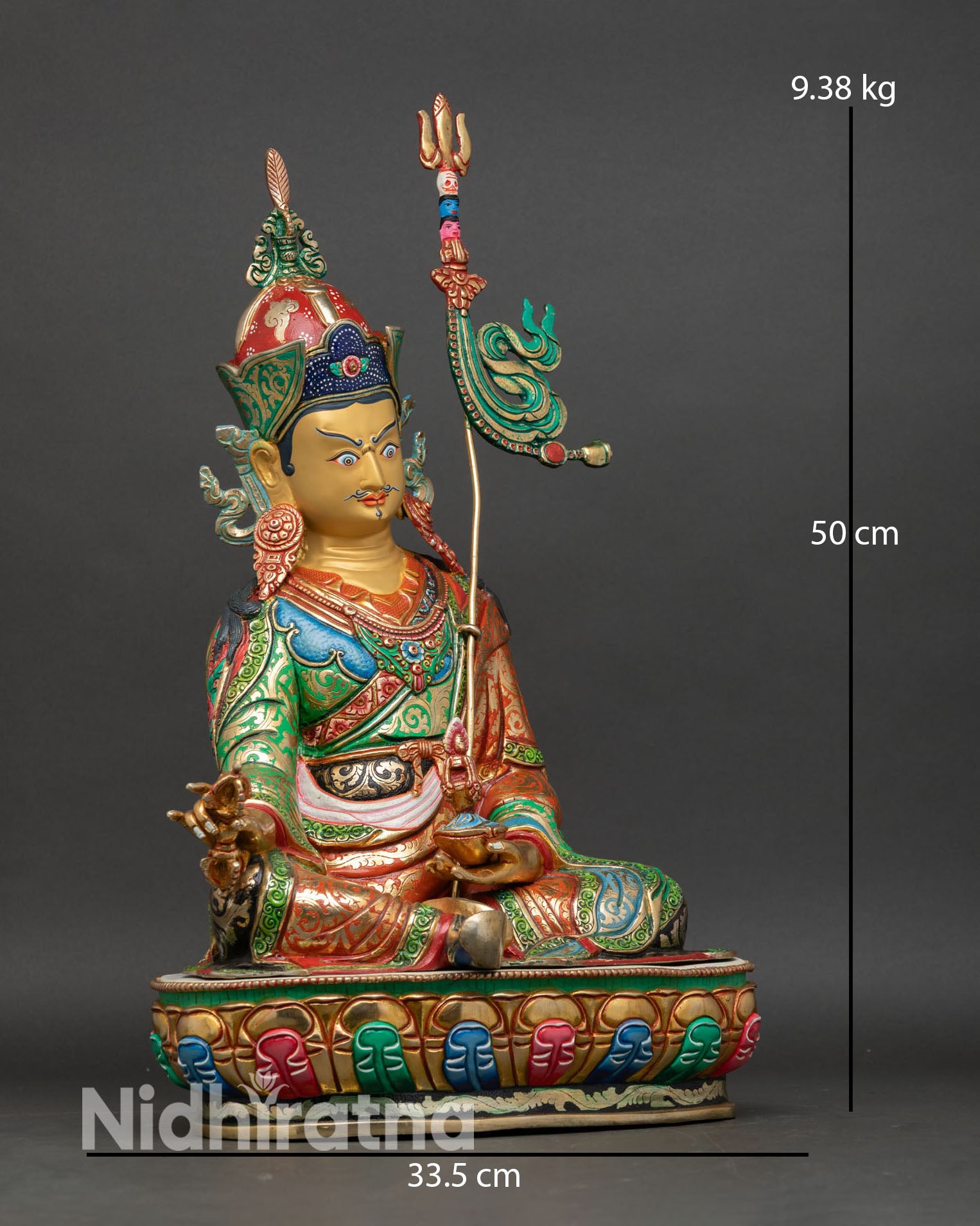 Right side view of Guru Rinpoche statue seated on lotus throne, holding vajra, copper and gold finish Nepal