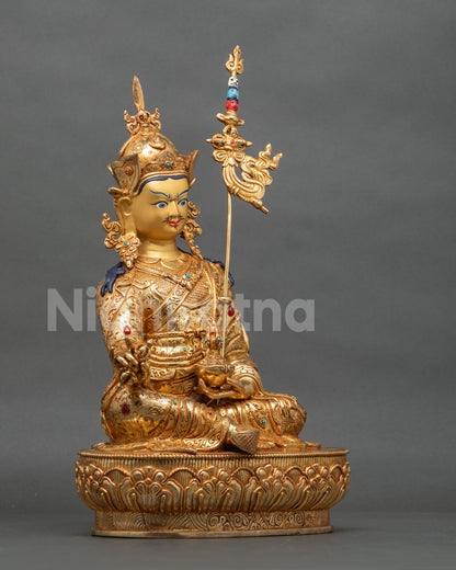 Right side view of Guru Rinpoche statue with khatvanga staff and lotus base