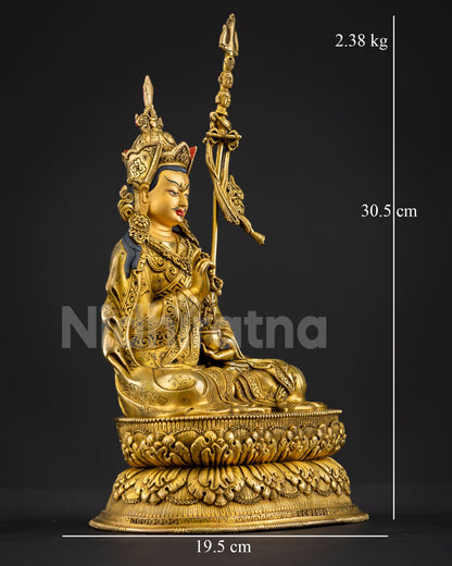 Right side view of Guru Tsokye Dorje statue holding vajra and ritual kapala