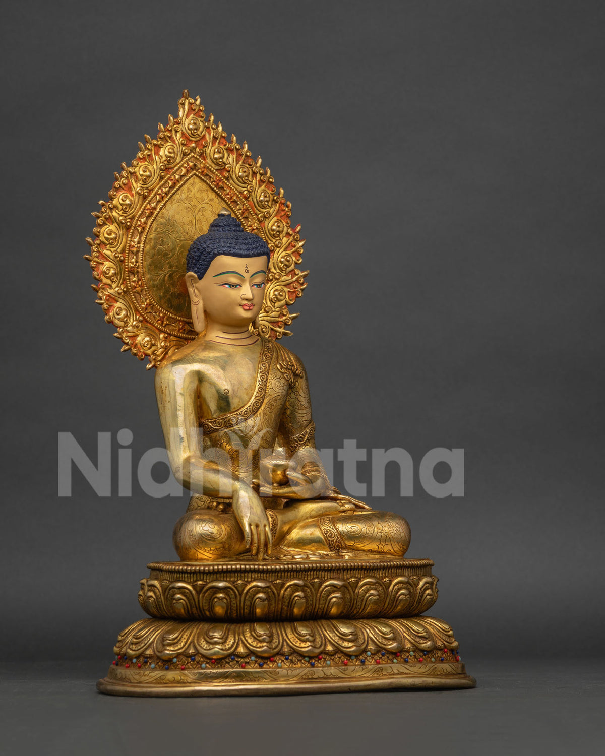 Right side view of handcrafted Buddha statue, patra bowl in hand, monastic robe patterns