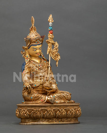 Right side view of handcrafted Guru Rinpoche statue on lotus pedestal in gold fire-gilded copper