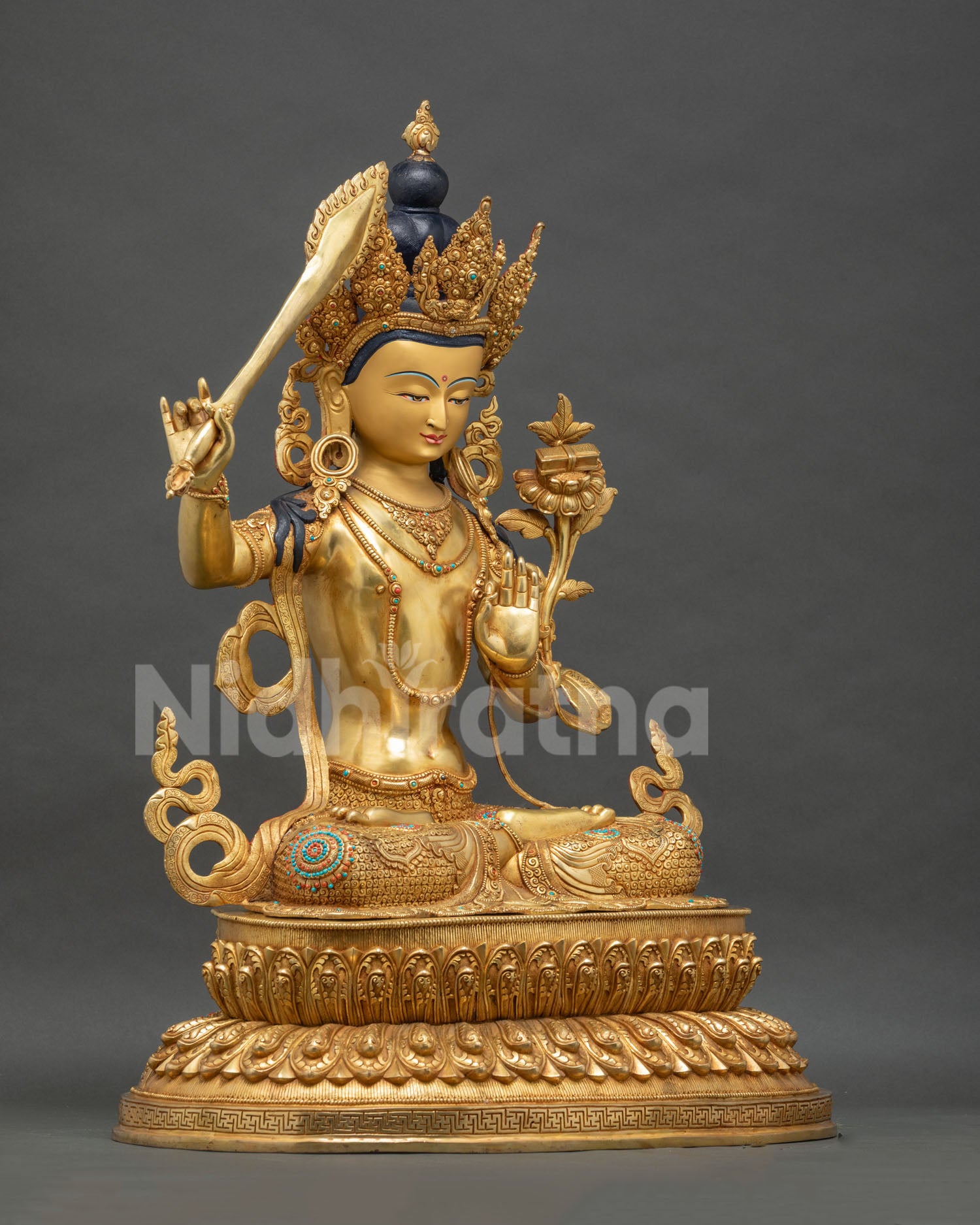 Right side view of handcrafted Manjushri statue with flaming sword, Nepal