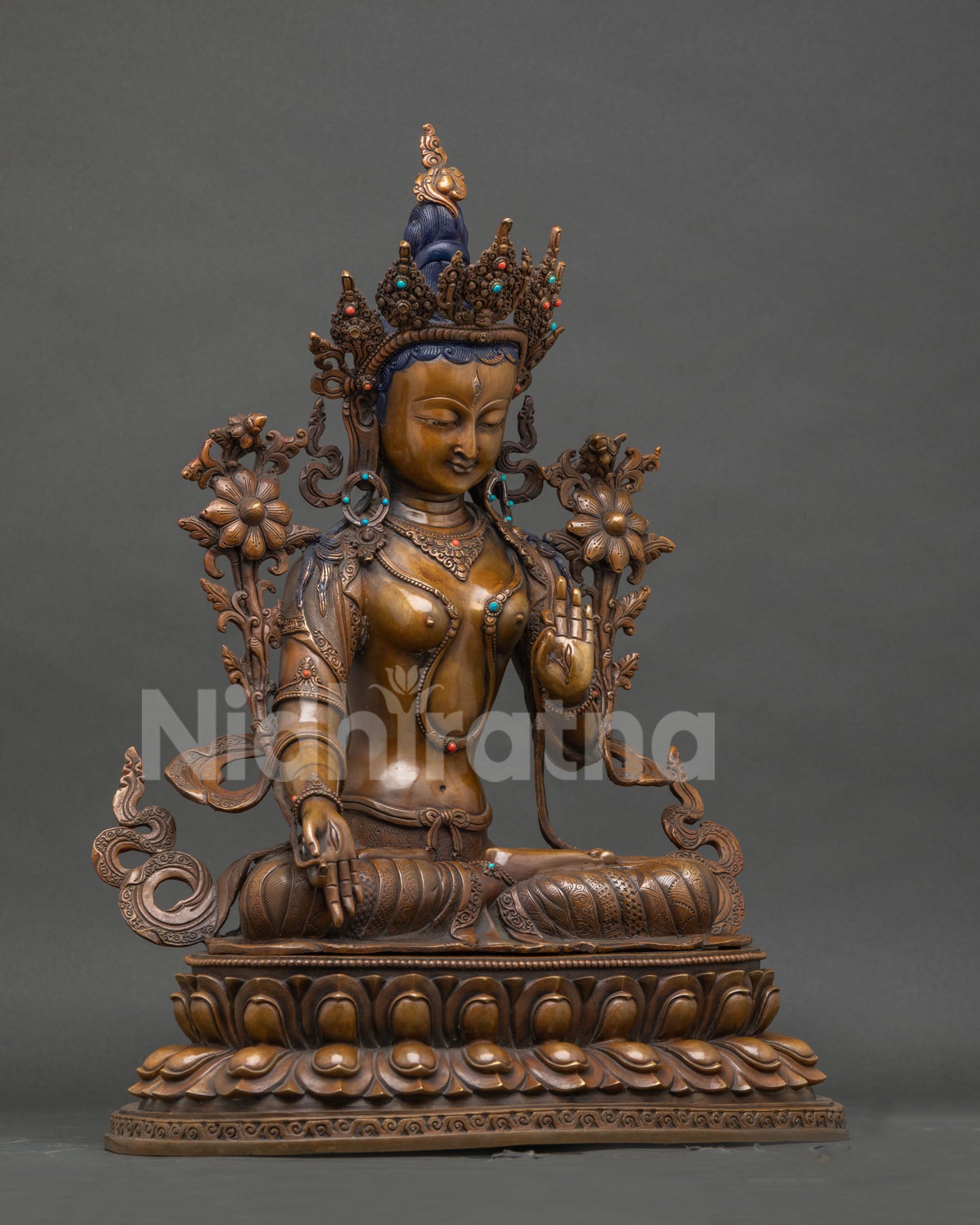 Right side view of handcrafted oxidized copper White Tara Buddhist statue