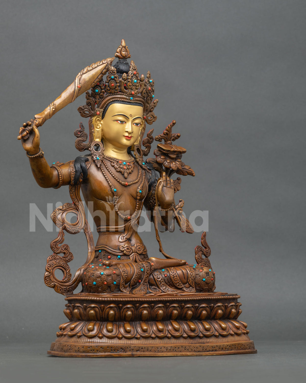 Right side view of handcrafted oxidized Manjushri copper statue on lotus base