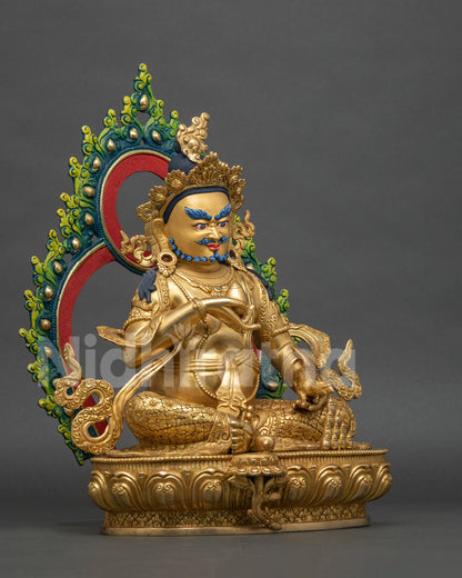 Right side view of handmade gold-gilded Yellow Dzambhala statue with ornate halo.