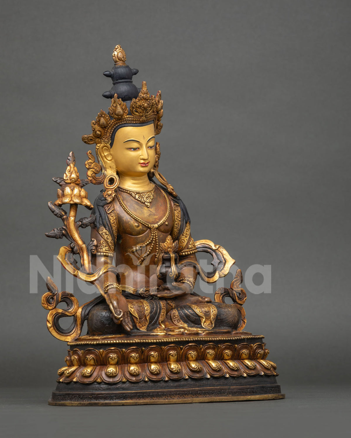 Right side view of Ksitigarbha oxidized copper statue seated on a double-lotus seat from Nepal