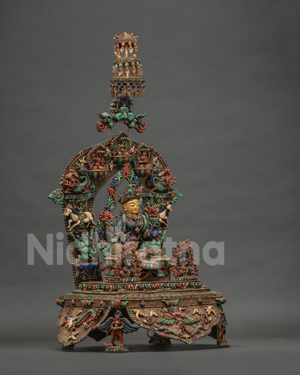 Right side view of Lapis Lazuli Green Tara statue with garuda carved four-sided base