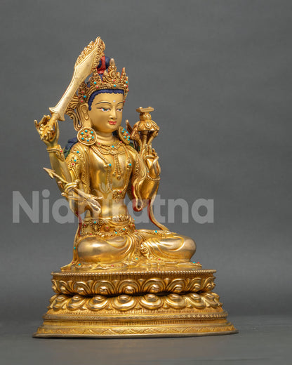 Right side view of Maha Manjushri copper statue holding flaming sword on a double lotus pedestal